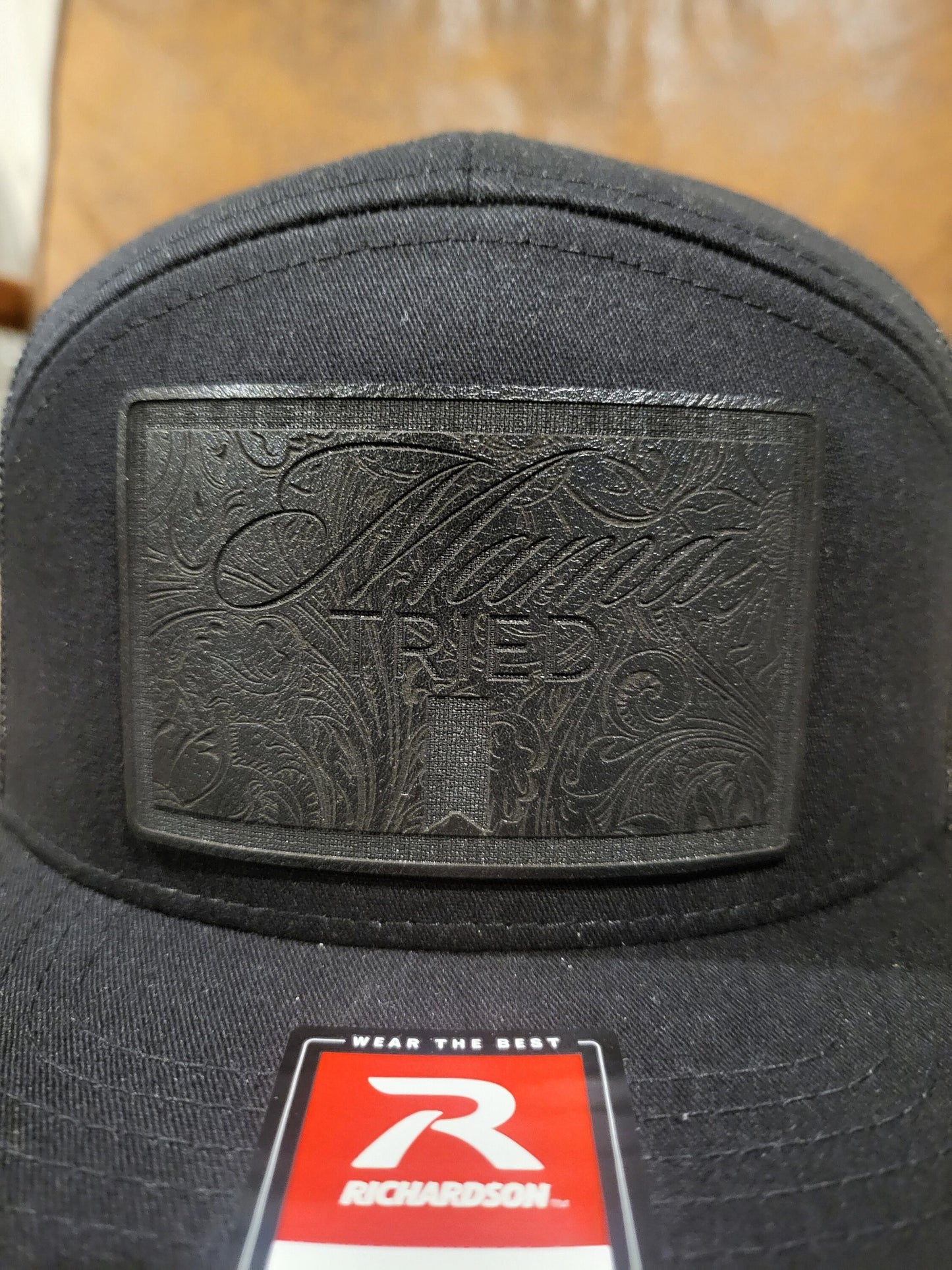 Mama Tried Mama Tried all black leather on a black Richardson 112 trucker round bill or 168 flat bill hat