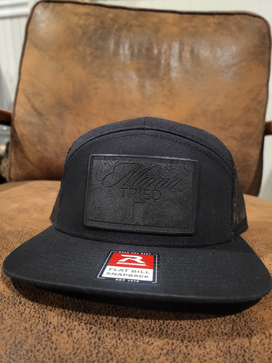 Mama Tried Mama Tried all black leather on a black Richardson 112 trucker round bill or 168 flat bill hat