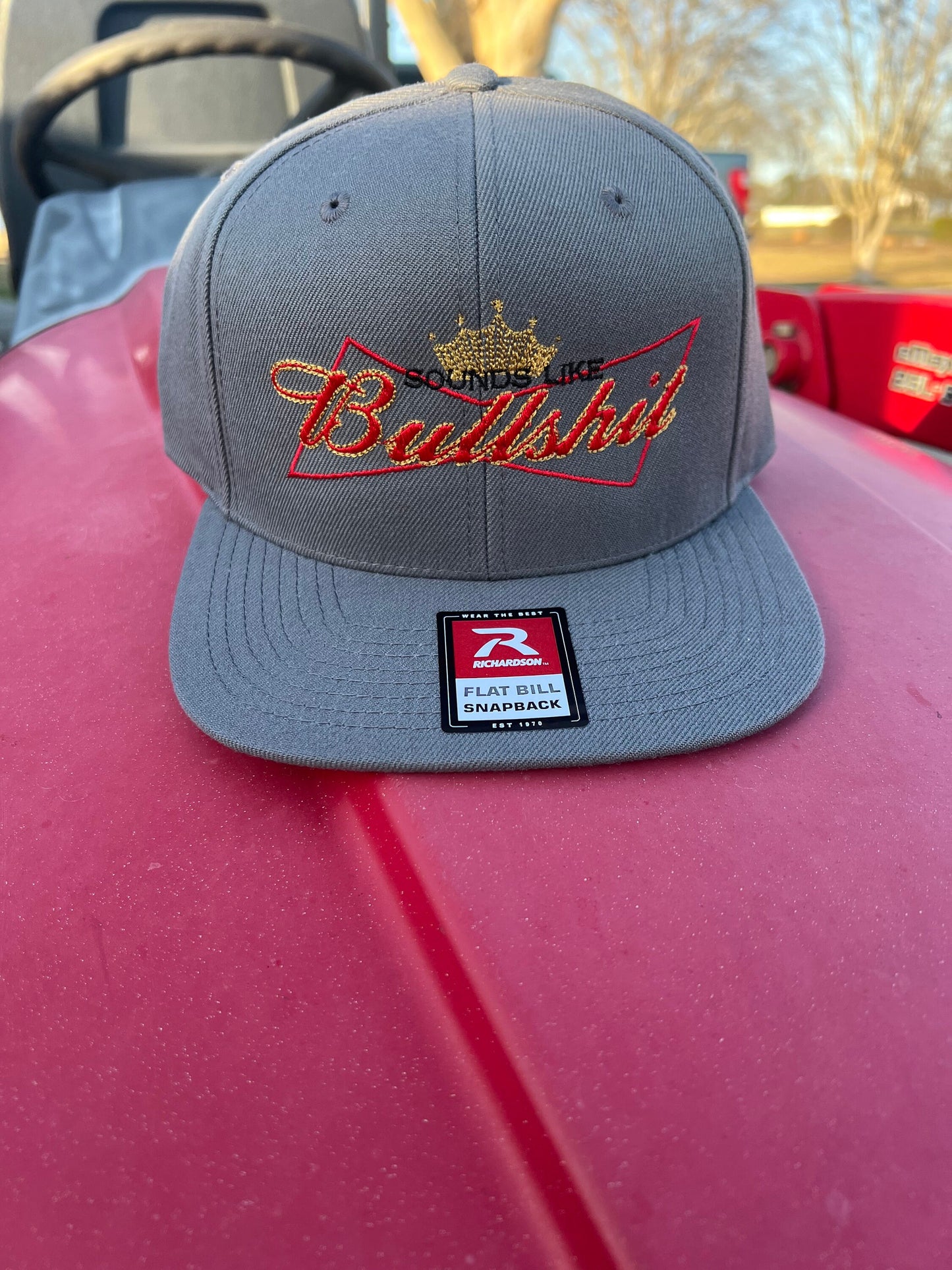 Sounds Like Bullshit embroidered hat on a Richardson 112 trucker round bill or 168 flat bill hat