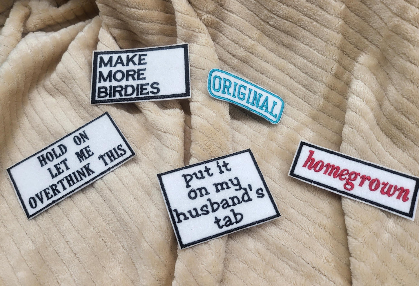 Bulk iron-on embroidered patches in a variety of styles. Embroidered on felt.