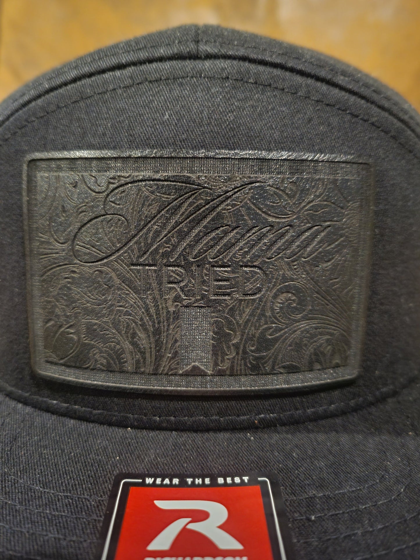 Mama Tried Mama Tried all black leather on a black Richardson 112 trucker round bill or 168 flat bill hat