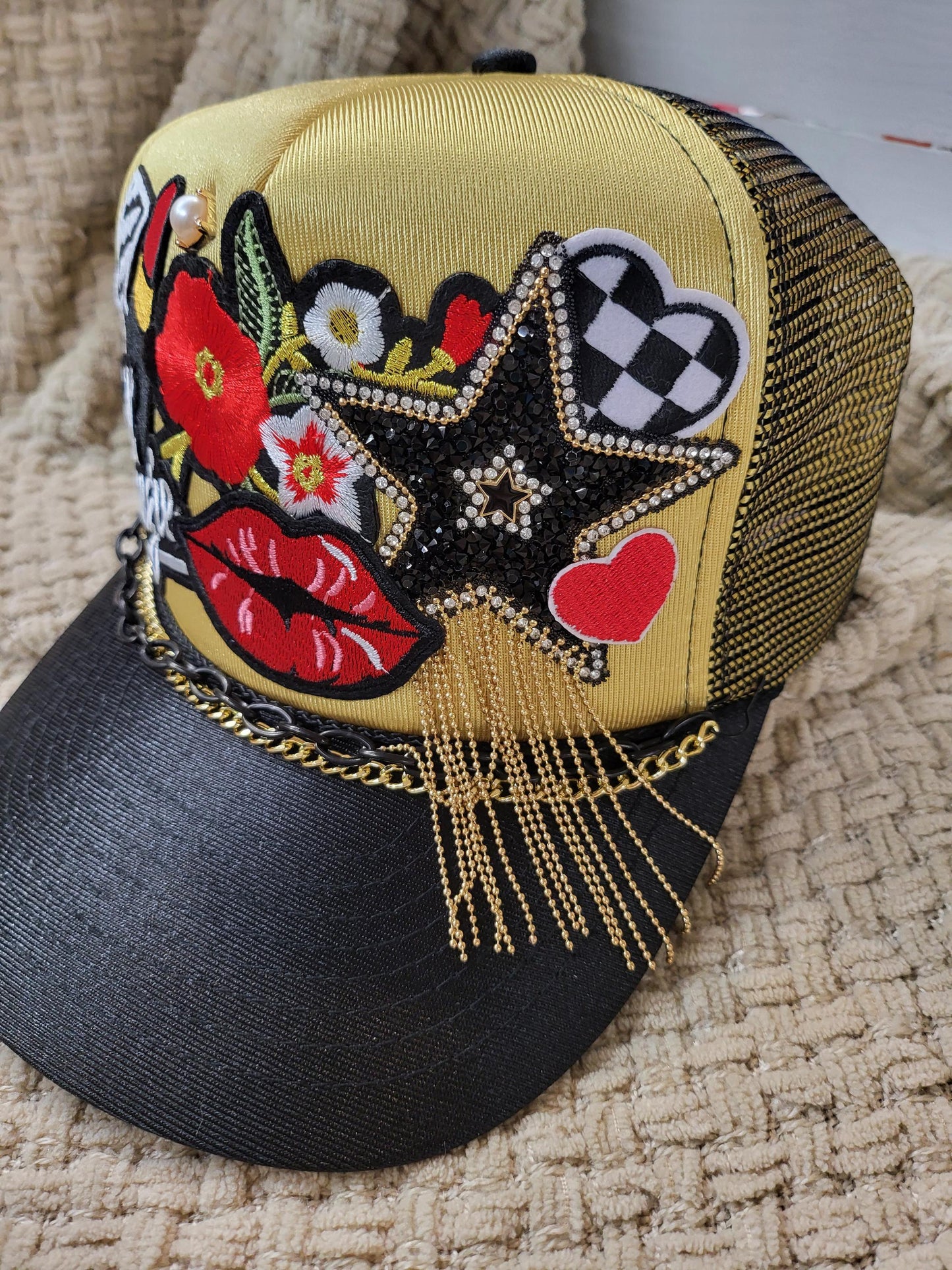 Lil' Boujie foam snapback trucker hat with red and gold accesories.
