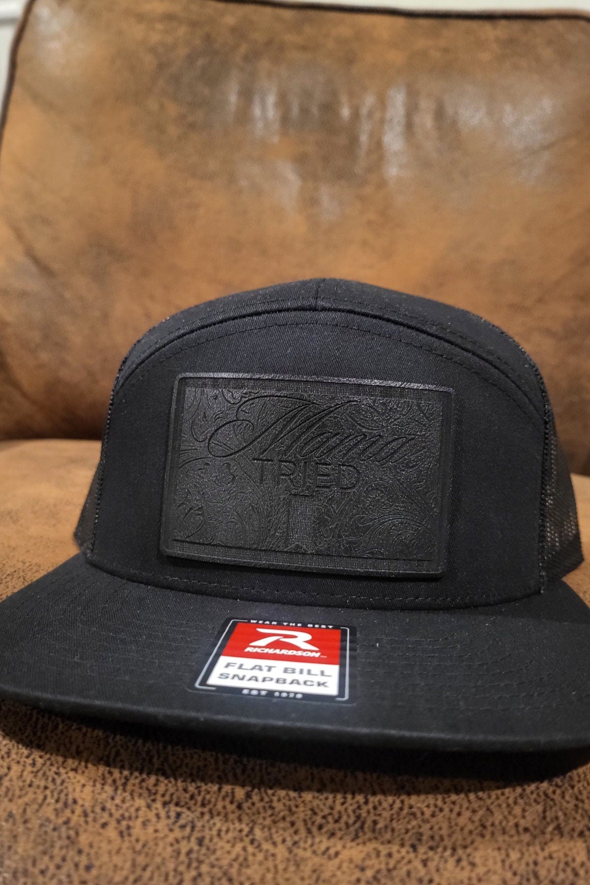 Mama Tried Mama Tried all black leather on a black Richardson 112 trucker round bill or 168 flat bill hat